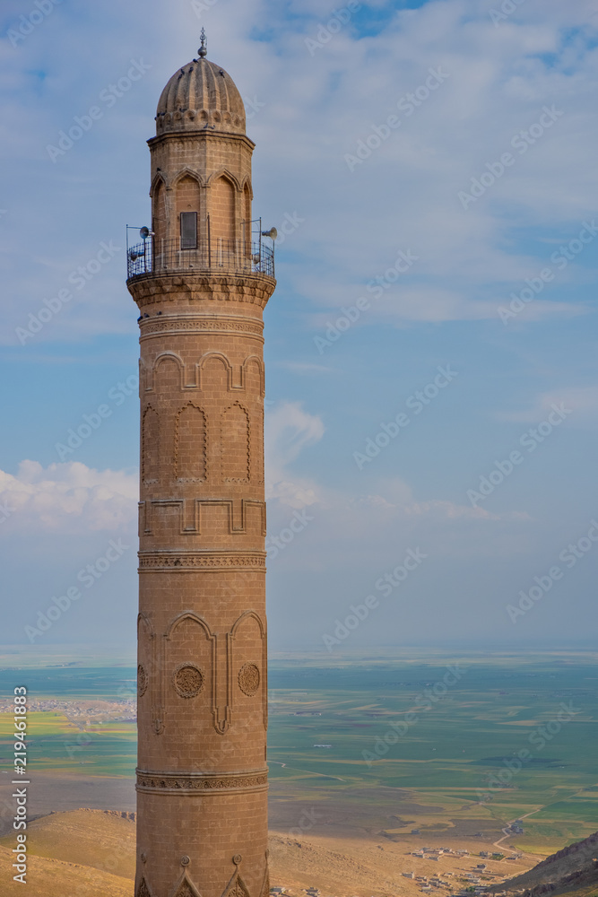 Minaret of the Great Mosque known also as Ulu Cami with mesopotamian plain in the background, Mardin, Turkey.