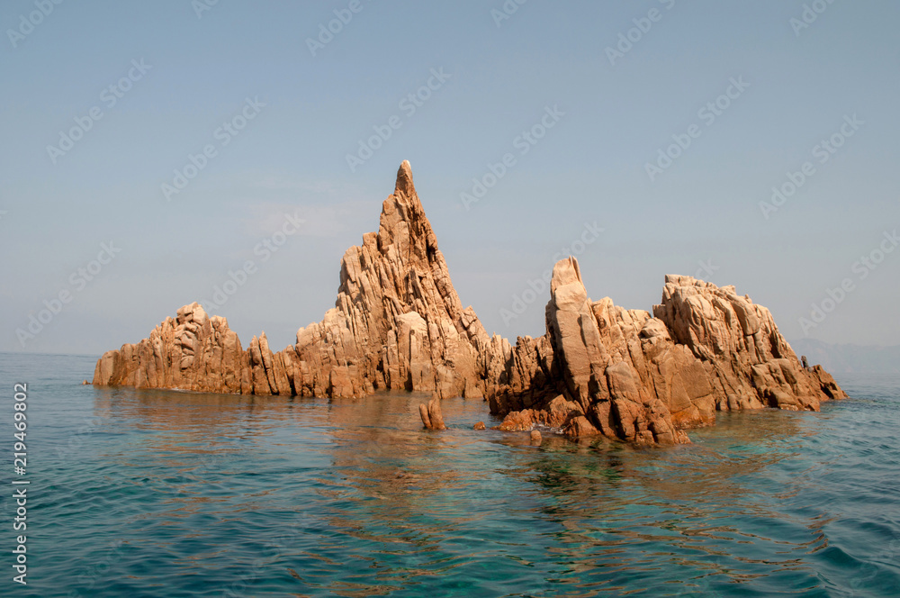 Early sun-lit rock, which rises from the sea - Corsica, France