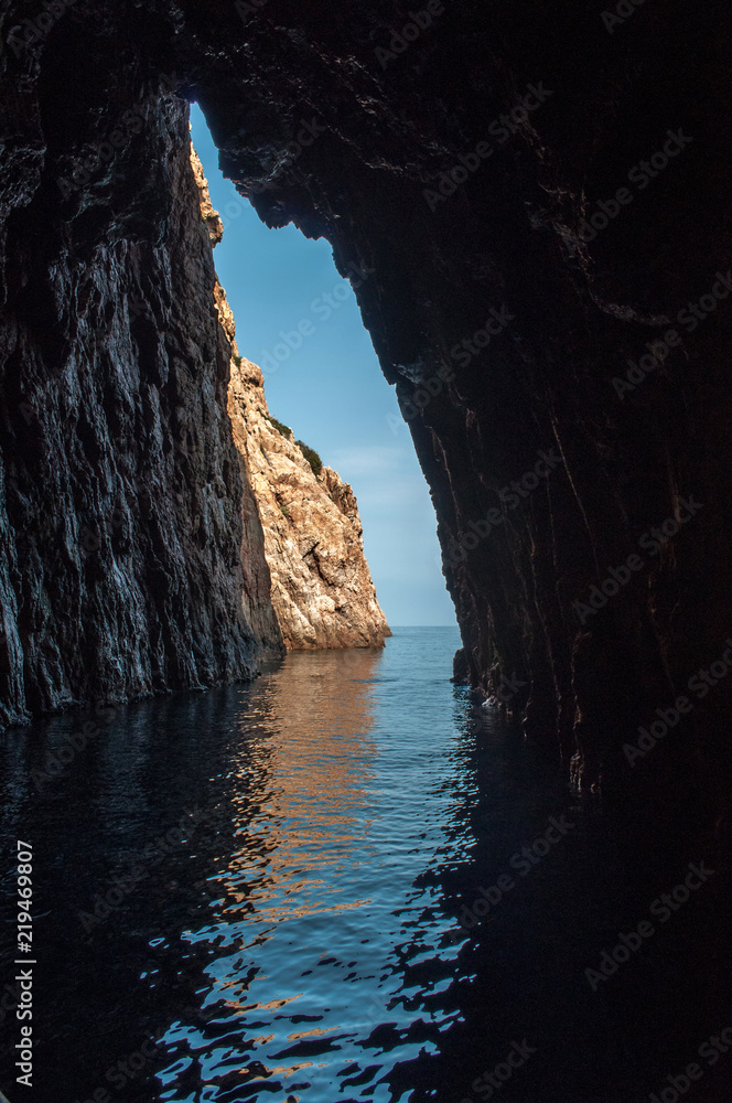 A view through a hole in a rock above the sea on the island of Corsica