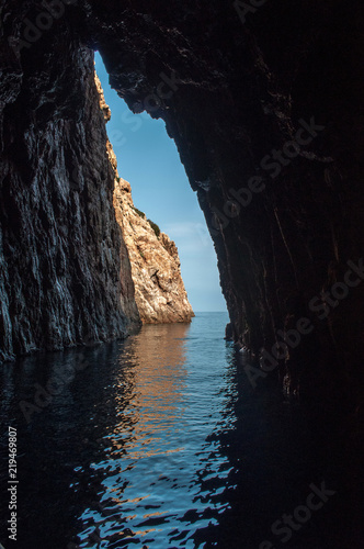 A view through a hole in a rock above the sea on the island of Corsica