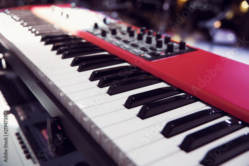 new red synthesizer. piano keys close-up. electronic musical instrument. professional DJ equipment