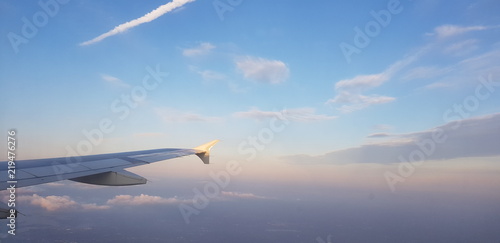 View of the wing of the plane, a contrail of another plane and the beautiful sky © Zoe