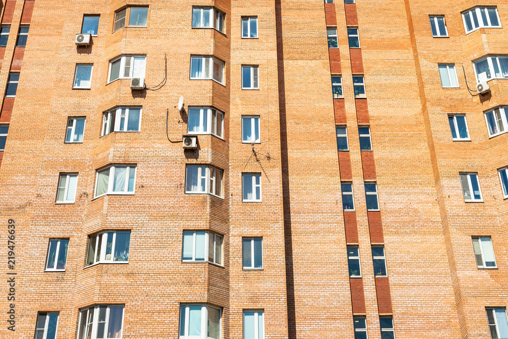 Fototapeta premium facade of urban brick multi-storey house