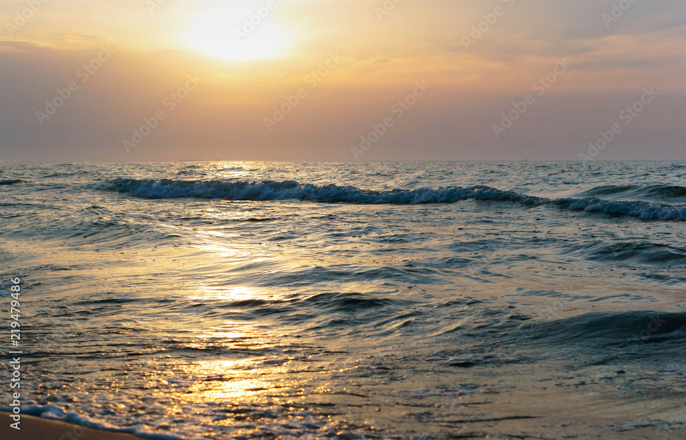 Sunset over the sea. Reflection of sunlight in the sea waves. Red sky in the rays of the sunset. Sunset over the sea. Reflection of sunlight in the sea waves. Red sky in the rays of the sunset.