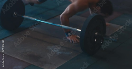 HANDHELD portrait of Caucasian male athlete doing high intensity workout in a functional gym. 4K UHD
