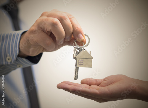 man holding a home key in his hand