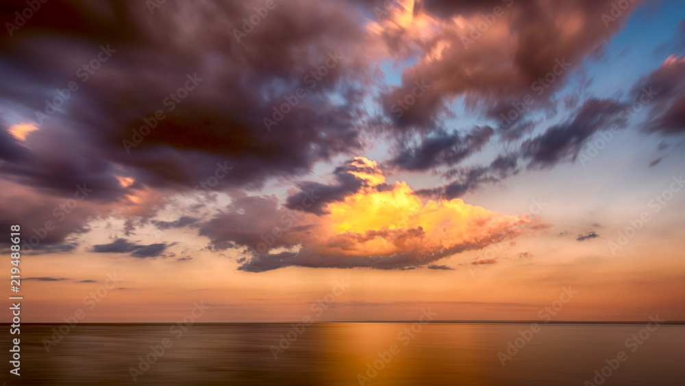 Golden Orange sunset clouds over Lake Superior Horizon