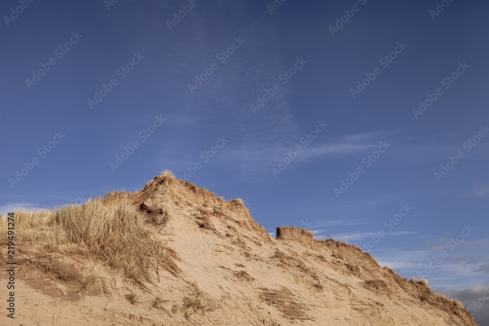 Sand dune at braunton burrows nature reserve with blue sky