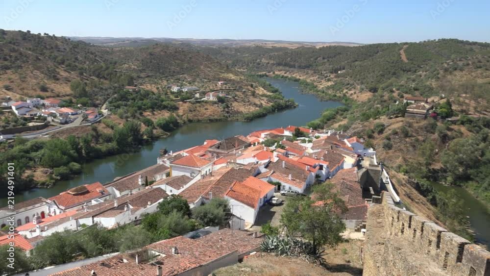 View of Guadiana river bend and residential houses of Mertola city on the ripe. Mertola. Portugal View of Guadiana river bend and residential houses of Mertola city on the ripe. Mertola. Portugal