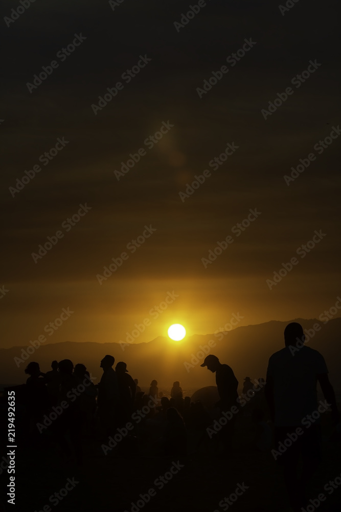 People watching sunset over Santa Monica beach in California