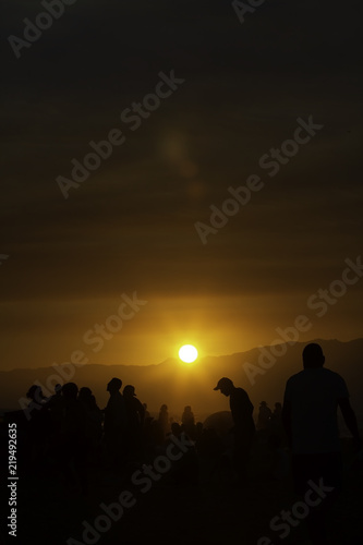 People watching sunset over Santa Monica beach in California