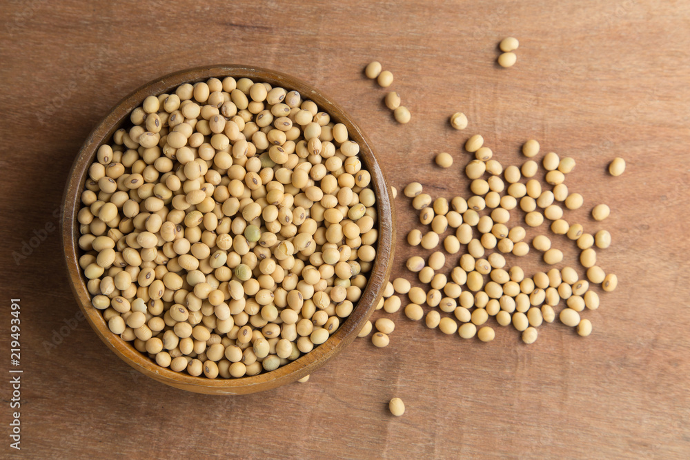 Soybeans in wooden bowl on wooden background. Soybeans in wooden bowl on wooden background.