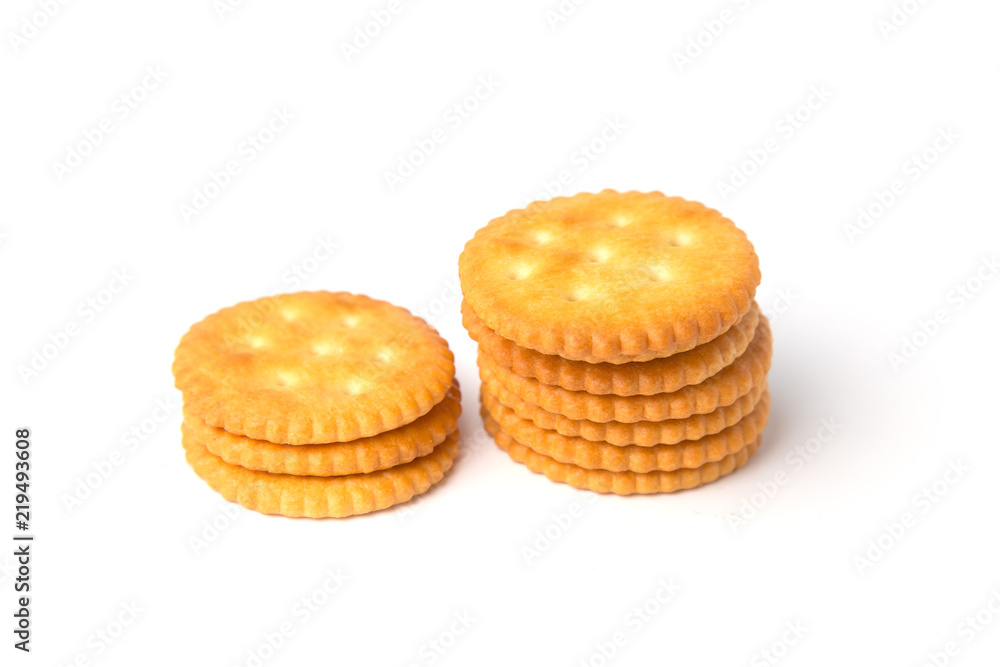 Round salted cracker cookies stacked isolated on white background. Round salted cracker cookies stacked isolated on white background.