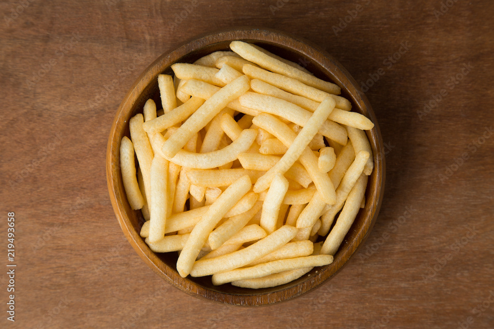 Top view of french fries or potato fry in wooden bowl putting on linen and wooden background. Top view of french fries or potato fry in wooden bowl putting on linen and wooden background.