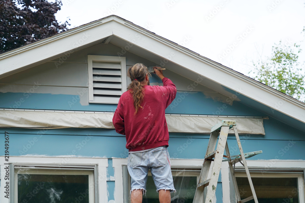 handyman painting house external wall for home renovation