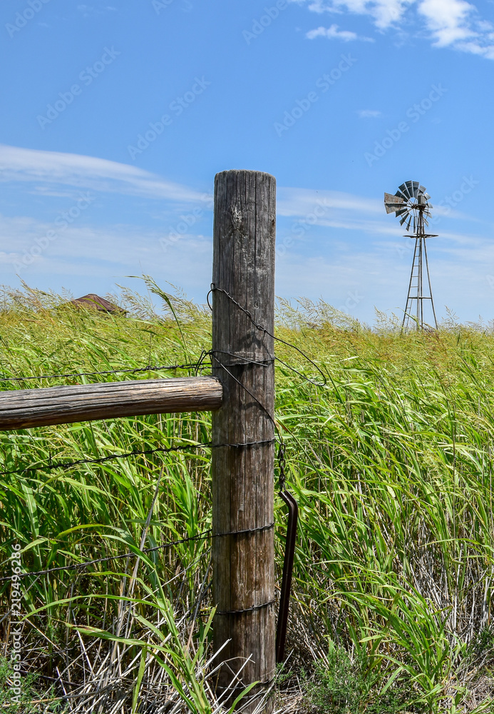 Old fencepost and windmill Old fencepost and windmill