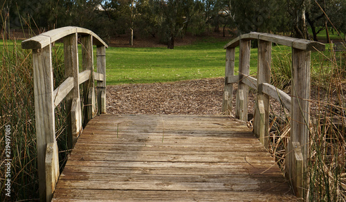 Fototapeta Naklejka Na Ścianę i Meble -  Wooden bridge at park