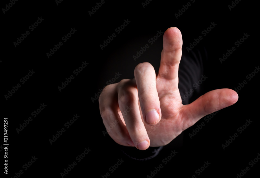 Man pointing or pressing something on black background Man pointing or pressing something on black background