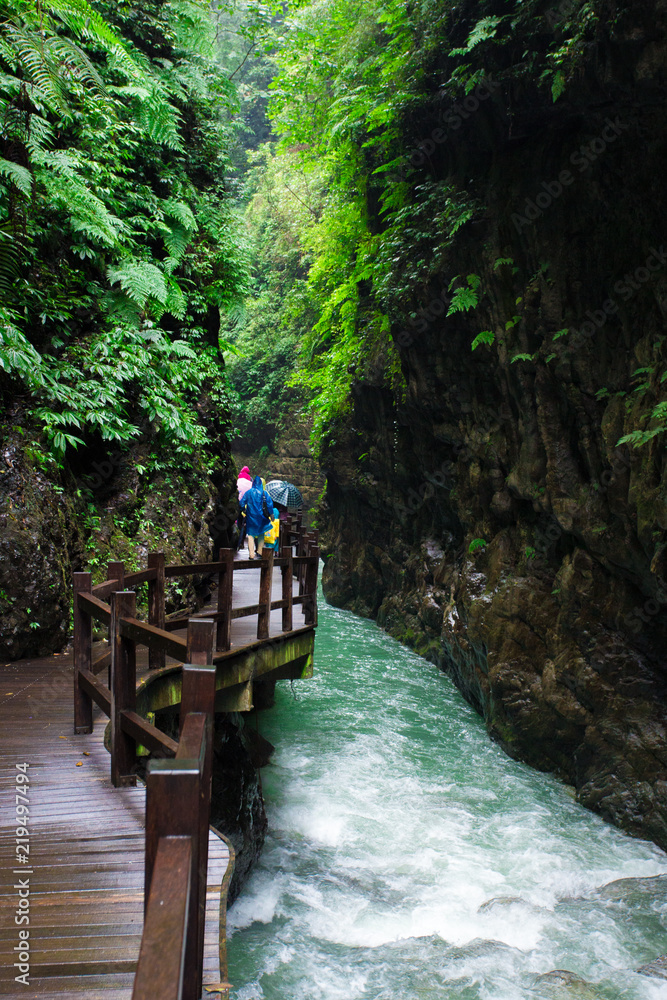 Tourists walk in the quiet valley, the stream in the valley is constantly flowing, in China chong'qing... Tourists walk in the quiet valley, the stream in the valley is constantly flowing, in China chong'qing...