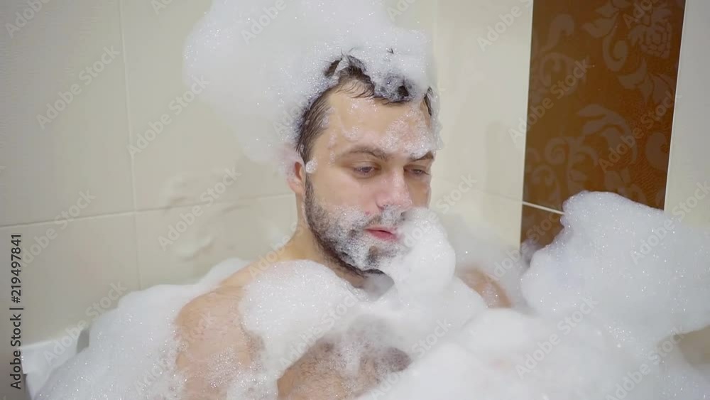 Portrait of adult man taking a bubble bath. Portrait of adult man taking a bubble bath.