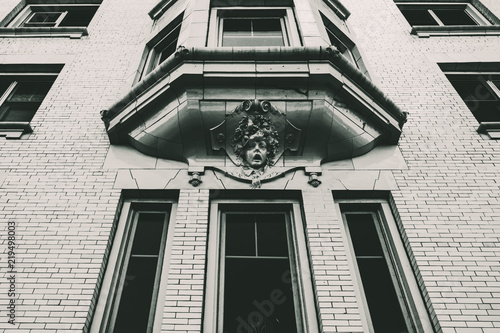 Perspective view of a bay window on a tall city building.