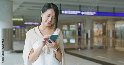 Photography Woman holding smart phone in the airport
