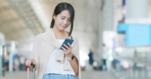 Photography Woman checking on cellphone in the airport