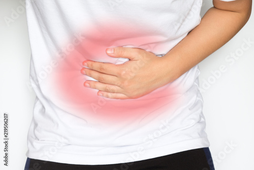 Man suffering from abdominal pain on white background.