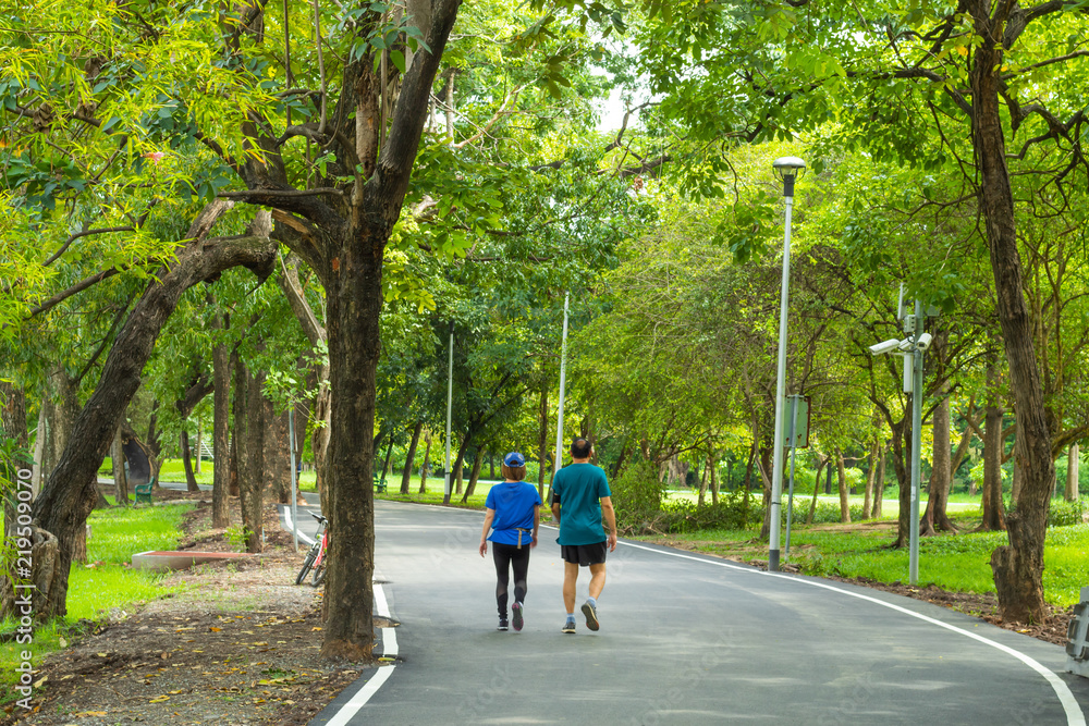 Man and woman walking on the street in the park.