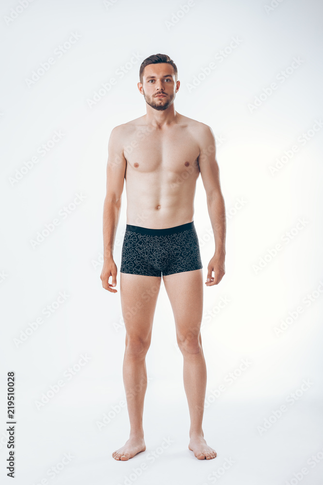 Full length portrait of a young sexy muscular male model in underwear
