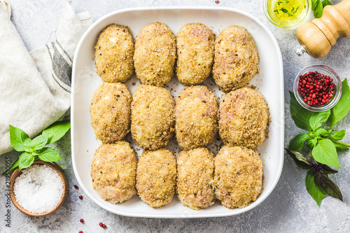 Obraz na plátně Healthy oven baked chicken rissoles on baking dish, ready for cooking