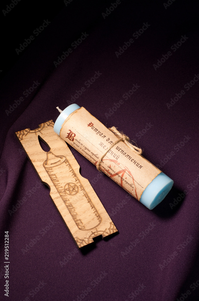 Fototapeta premium The magic candle on a colored background