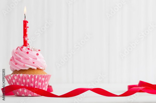 pink cupcake on white wooden background