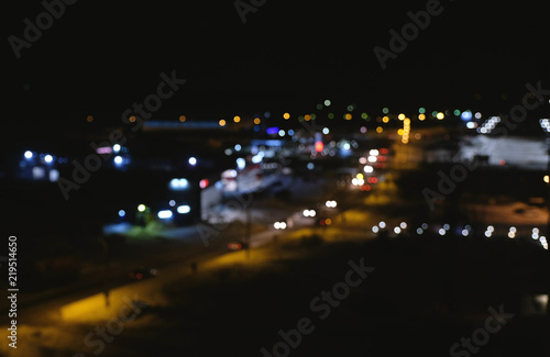 Blurred view of the city and the road from a height. Blurred cars traffic in city. Night.