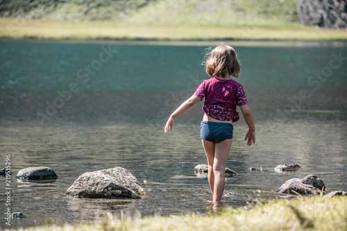 Girl at Hintersee glacier lake at Nationalpark Hohe Tauern in Pinzgau in the Austrian Alps