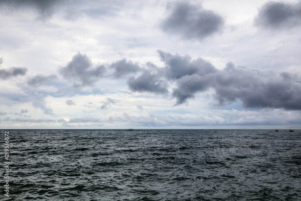 Horizon at sea in front of the storm as a background