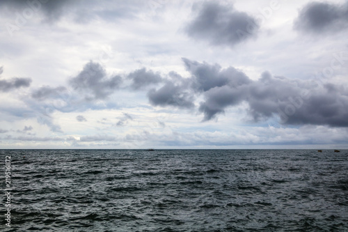 Horizon at sea in front of the storm as a background