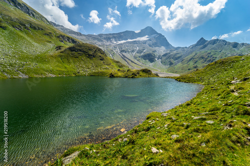 Fototapeta Naklejka Na Ścianę i Meble -  The glacie lake Schwarzkarlsee in the Austrian Alps at Nationalpark Hohe Tauern at 2119 meter in Pinzgau