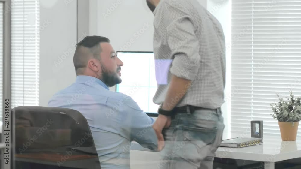 IT administrator helping office worker with computer IT administrator helping office worker with computer