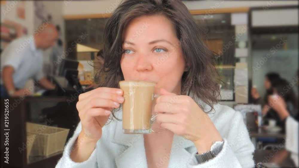 Beautiful caucasian woman holding a cup of coffee and drinking. Beautiful caucasian woman holding a cup of coffee and drinking.