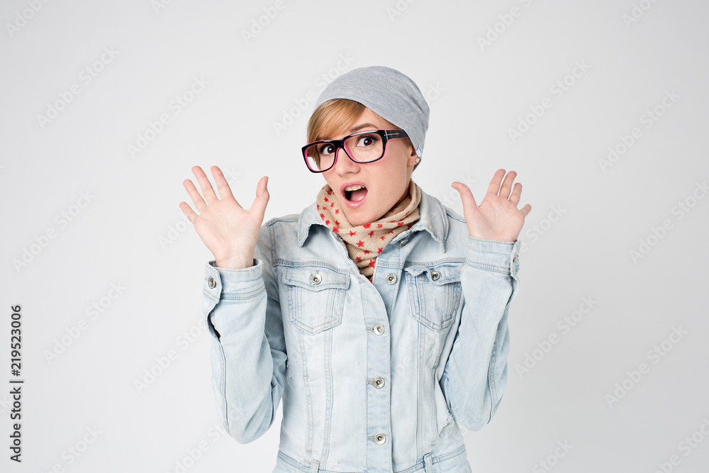 Young hipster surprised woman in winter hat and glasses Young hipster surprised woman in winter hat and glasses