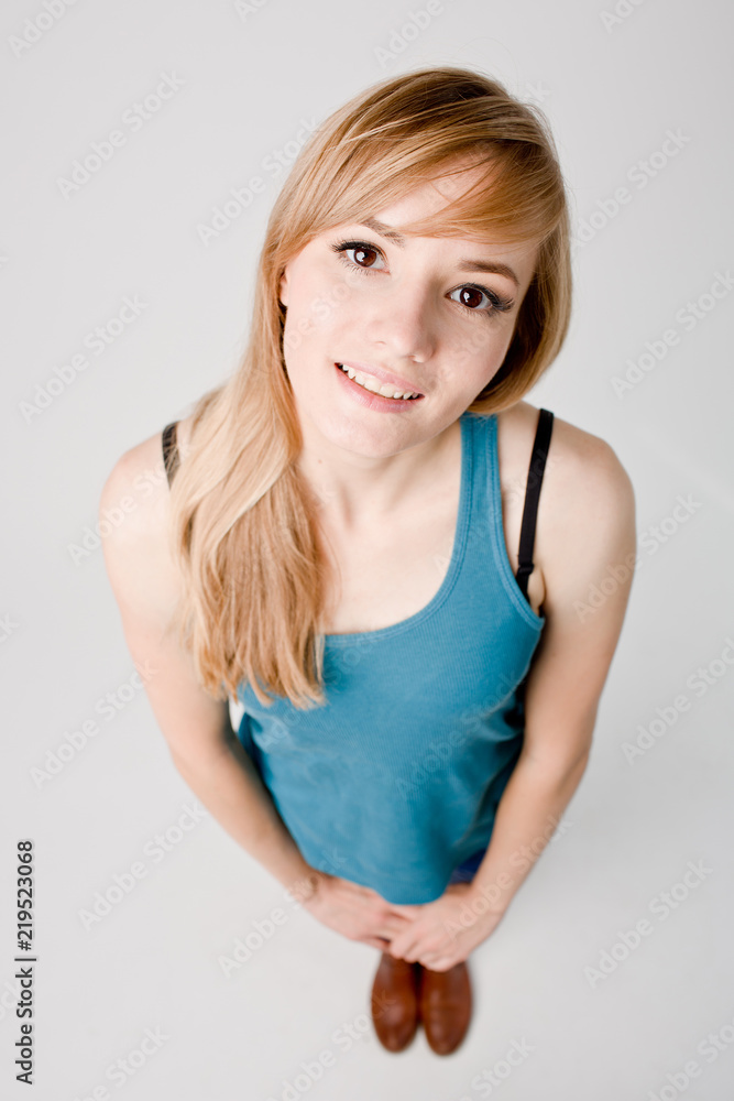 Smiling cheerful young woman doing selfie on white background Smiling cheerful young woman doing selfie on white background