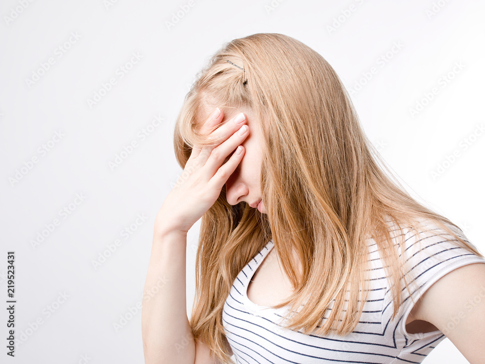Young beautiful woman with long light hair in bad mood, crying, feels bad and in depression Young beautiful woman with long light hair in bad mood, crying, feels bad and in depression
