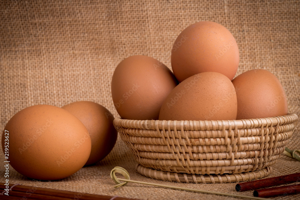 Set Eggs in a basket on gunny (sackcloth) background Set Eggs in a basket on gunny (sackcloth) background