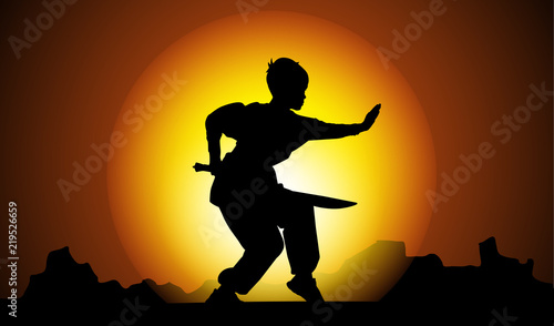 Boy silhouette showing Kung Fu element in sunset