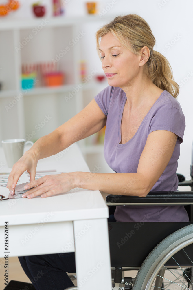disabled woman in wheelchair sitting at the table