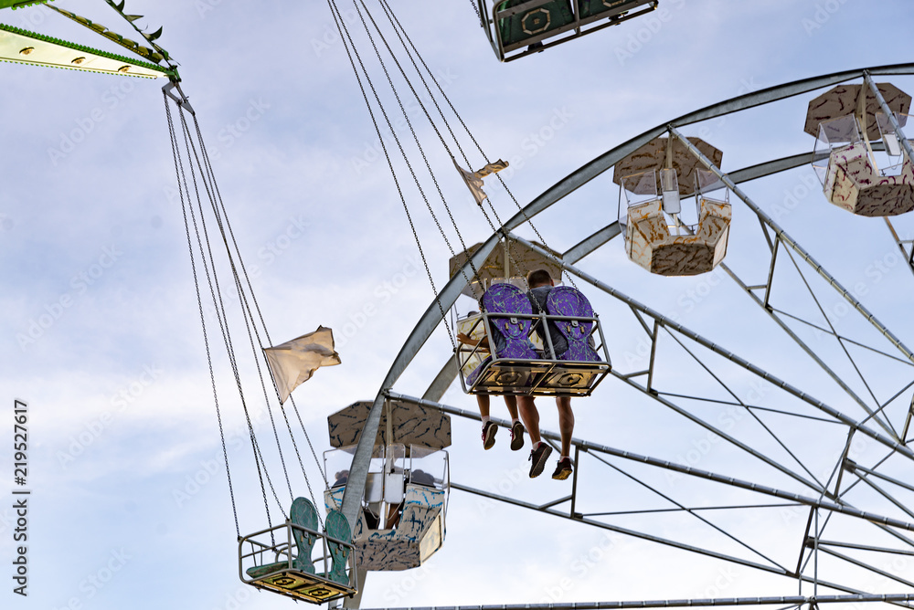 fun in the lunapark, people on the rollercoaster and big wheel fun in the lunapark, people on the rollercoaster and big wheel