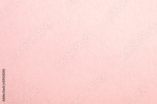 Recycled craft paper textured background in light faded pale pink color