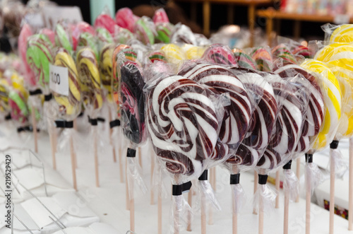 Display of colourful, spiral candy lollipops.