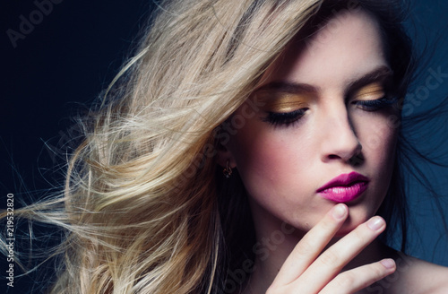 Beautiful blonde hair woman with beauty makeup pink lipstick